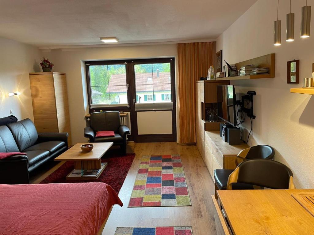 a living room with a couch and a table at Ferienwohnung Inzell mit Bergblick in Inzell