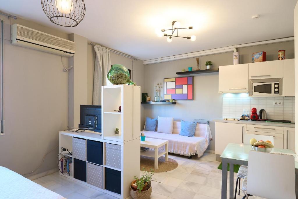 a small living room with a bed and a kitchen at Casa Curro en Baena in Baena
