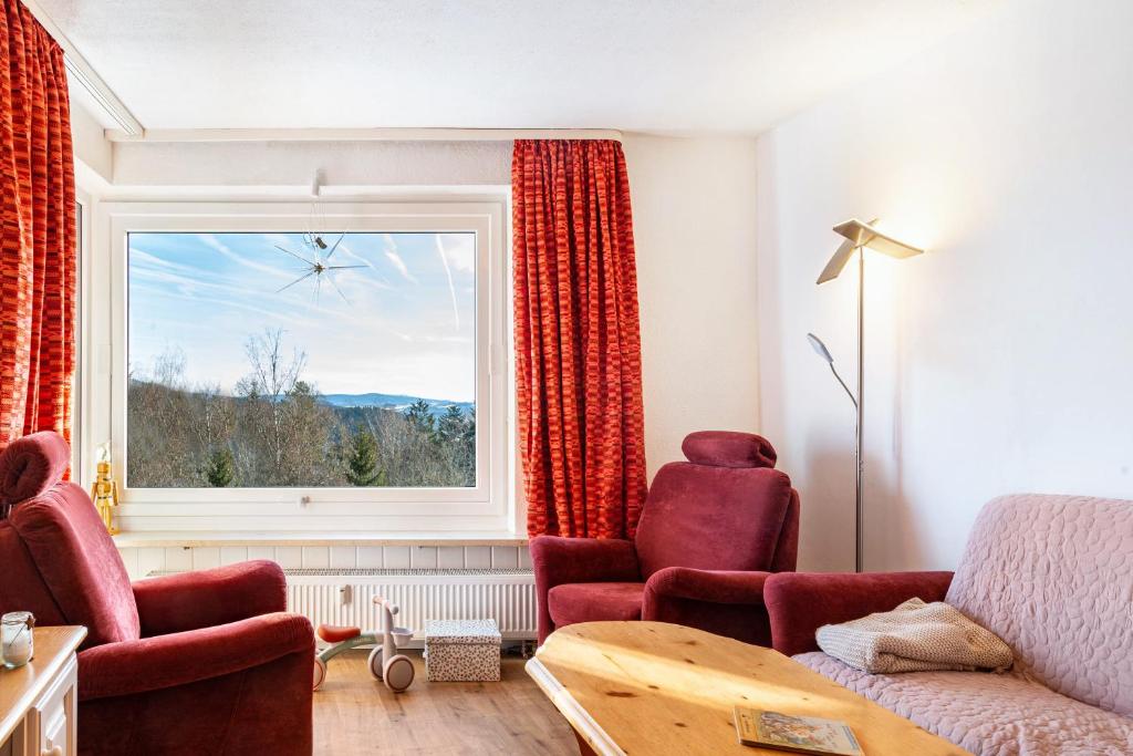 a living room with a couch and a window at Wohnung Fuchsenstein-Foxy in Spiegelau