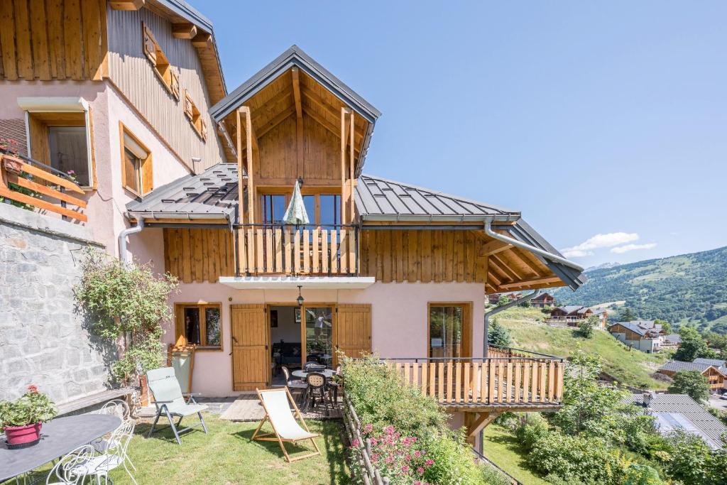 a house in the mountains with a balcony at La Mouliniere 1 in Valloire