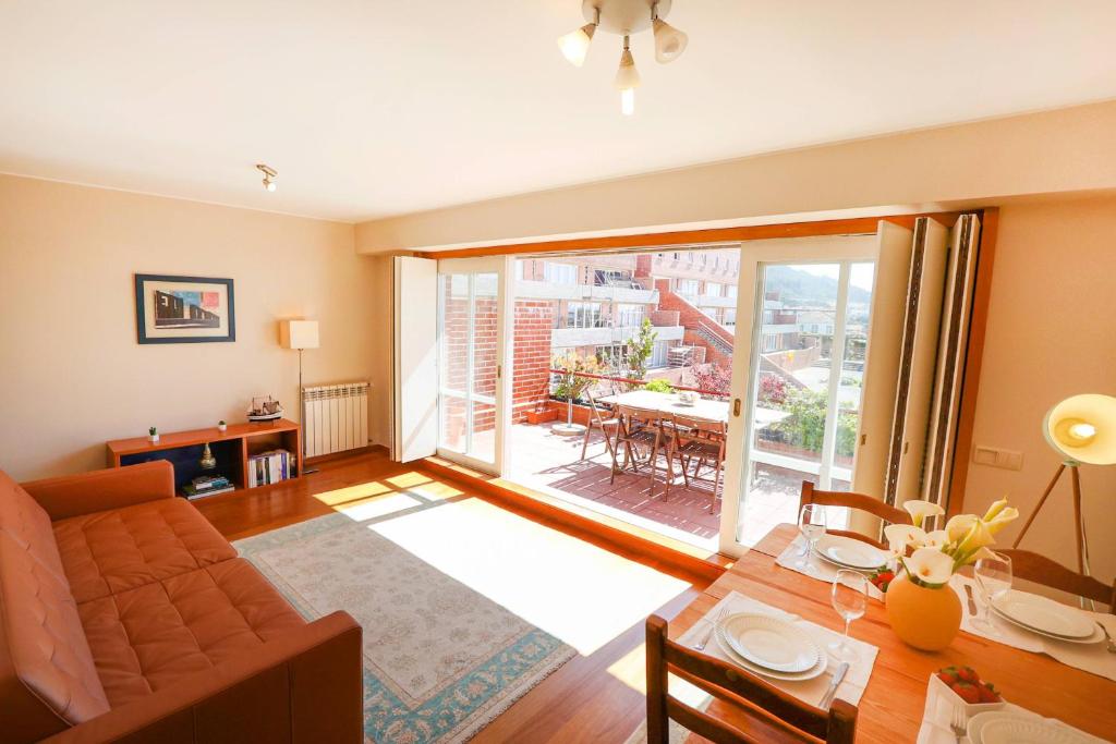 a living room with a couch and a table at Bahia Sea View Apartment in Caminha