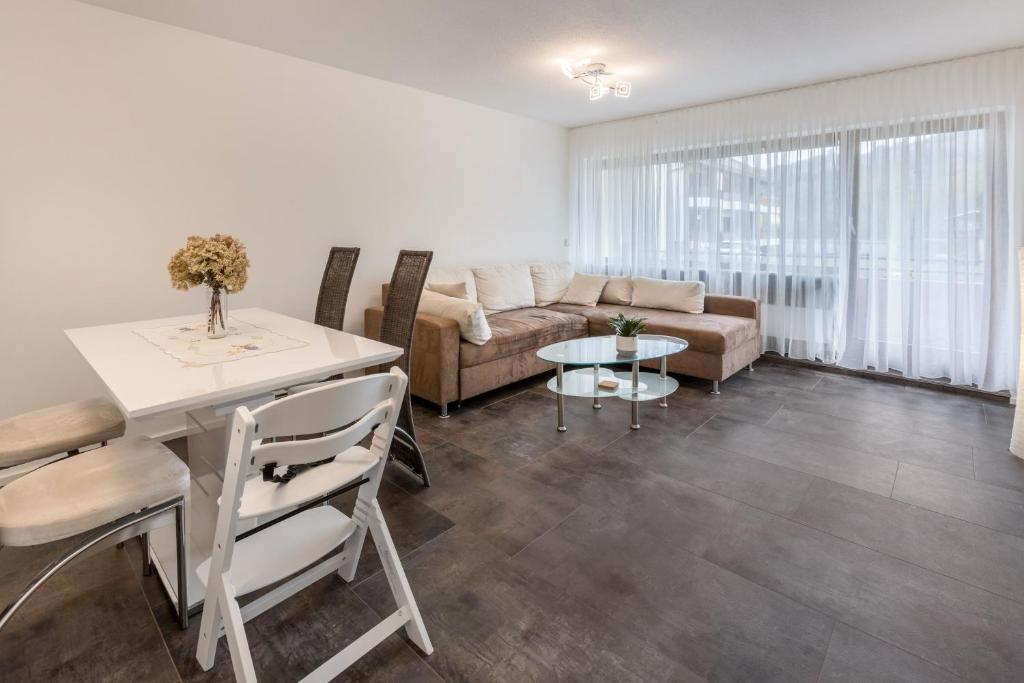 a living room with a couch and a table at Heidis Dihei in Büsingen