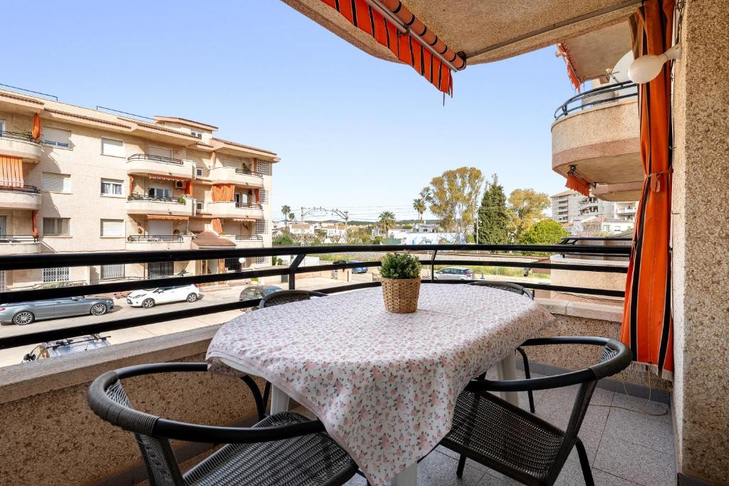 a table and chairs on a balcony with a view at Apartamentos Cunidor - Cunit in Cunit