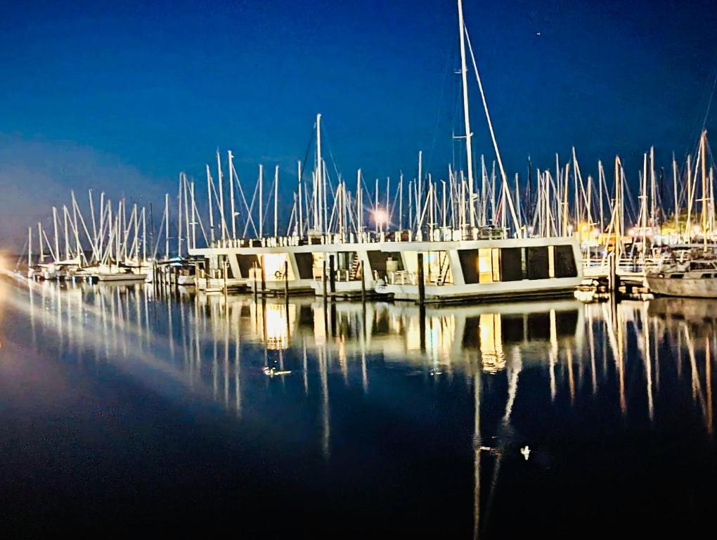 a group of boats docked in a marina at night at Floating Home Nr 1a in Laboe