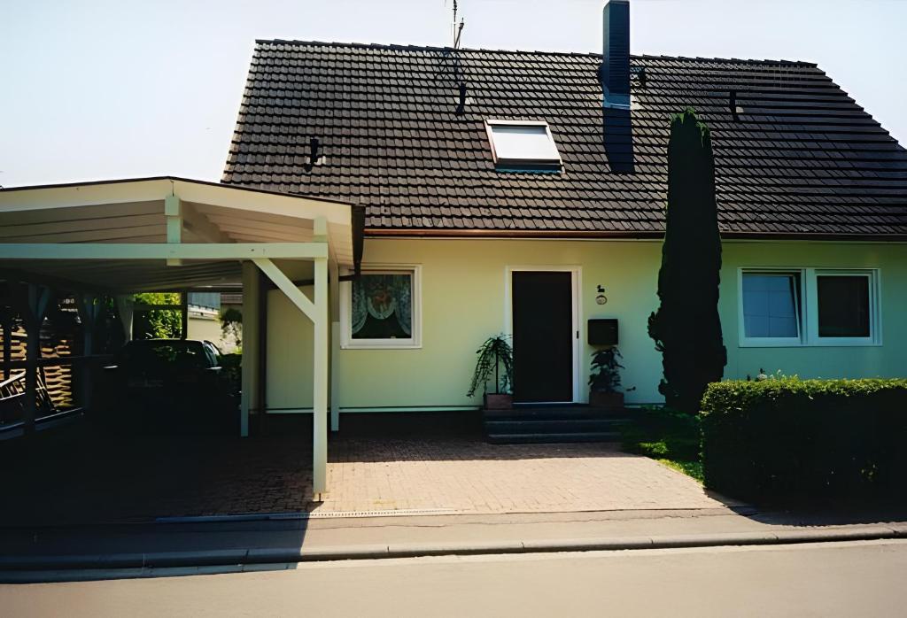 a small yellow house with a roof at Haus Wehrle in Breisach am Rhein