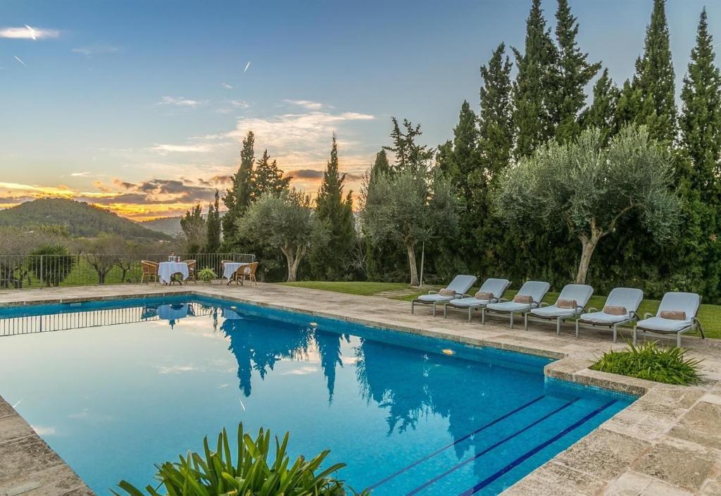 a swimming pool with lounge chairs next to at Historic Finca in Mallorca Up To 8 in Andratx