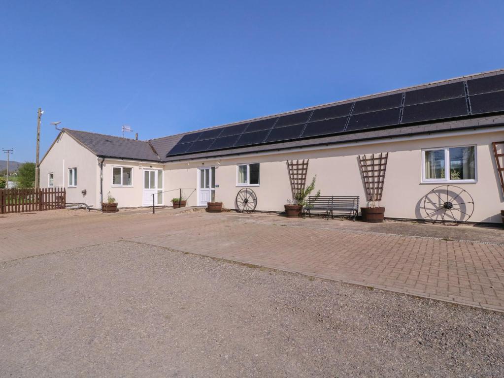 a large white building with solar panels on it at The Turbles - Swallows Nest in Castlemorton