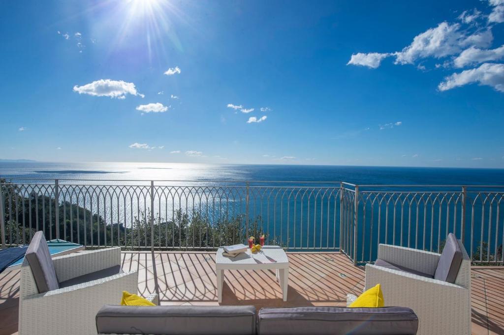 a patio with a view of the ocean on a balcony at Villa Domus Augusto in Conca dei Marini