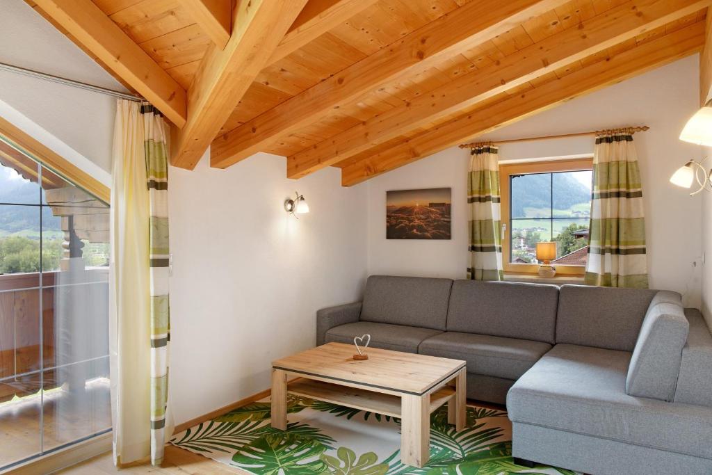 a living room with a couch and a table at Ferienwohnung Haus Brugger in Uttendorf