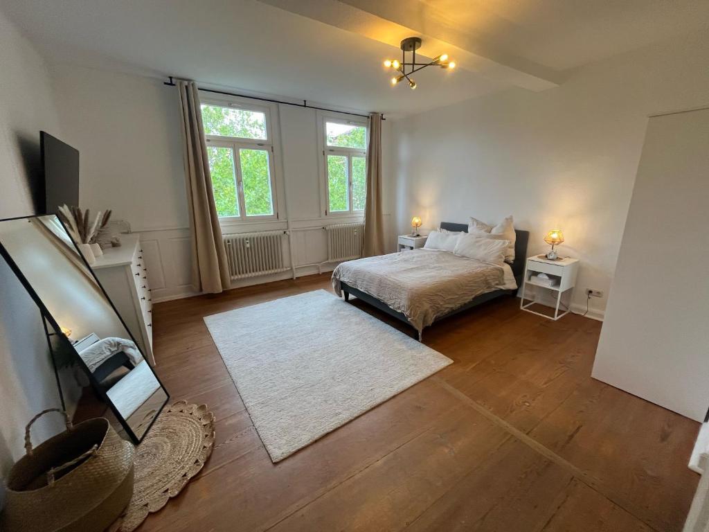 a bedroom with a bed and a large window at Charmante Altbauwohnung in Erlangen