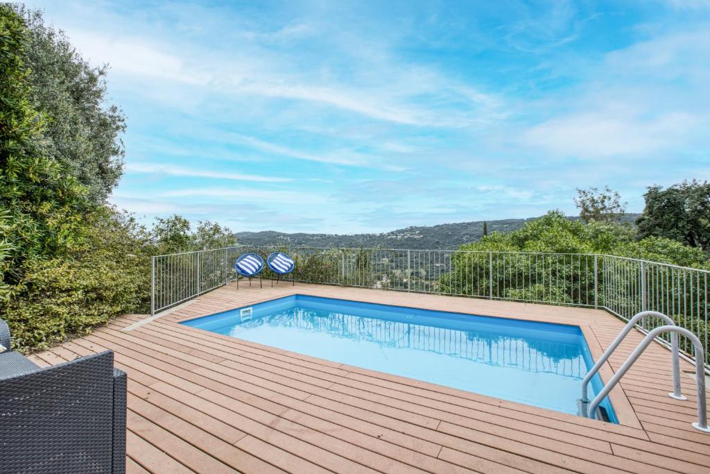 a swimming pool on top of a wooden deck at Casa Mathilda in Calonge