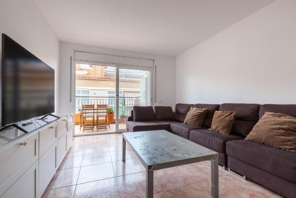 a living room with a couch and a table at Malgrat in Malgrat de Mar