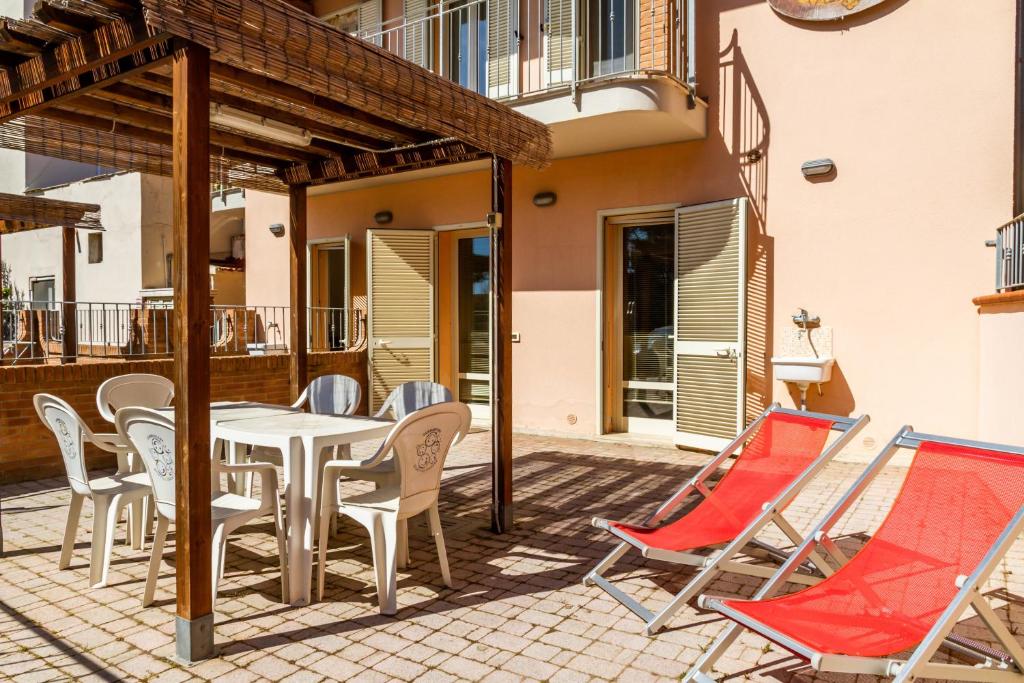 a patio with a table and chairs on a patio at Terra in Follonica