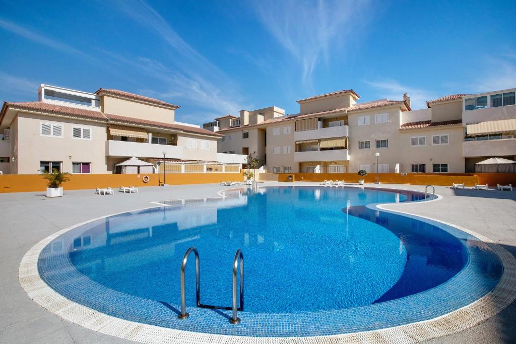 a large swimming pool in front of a building at Oramas Beach House – Pool & Terrace in Puertito de Güímar