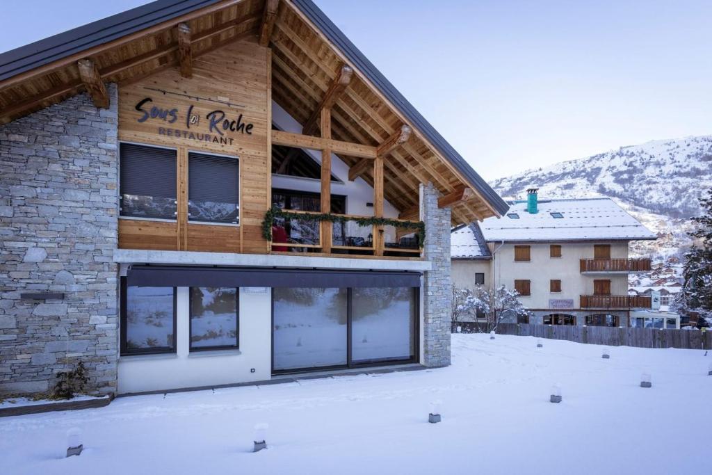 a building with a sign for a ski lodge at Chalet Le Strato in Valloire