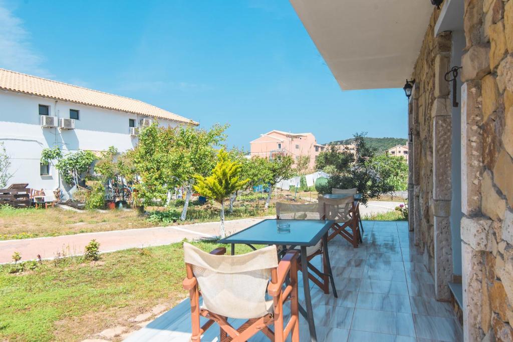 a patio with a table and chairs on a balcony at Mirage Arillas Studio Type B11 in Arillas