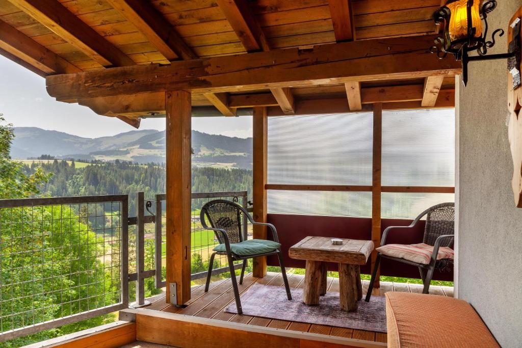 a porch with chairs and a table and a view at Haus Auner Top 4 in Westendorf