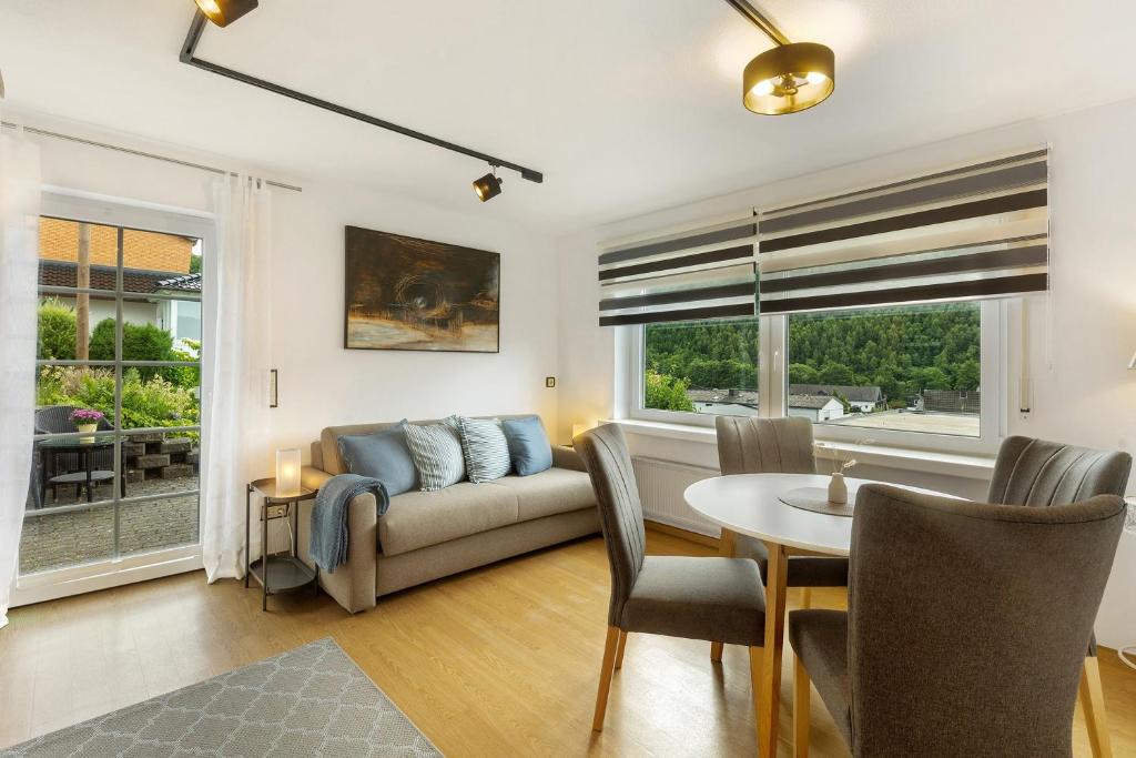a living room with a couch and a table at Schwalbennest in Lennestadt