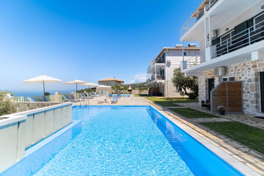 a swimming pool in a villa with a view of the ocean at Superior Apartment A in Tsoukalades