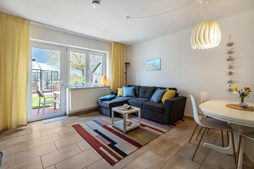 a living room with a couch and a table at Meerfamilie in Noer