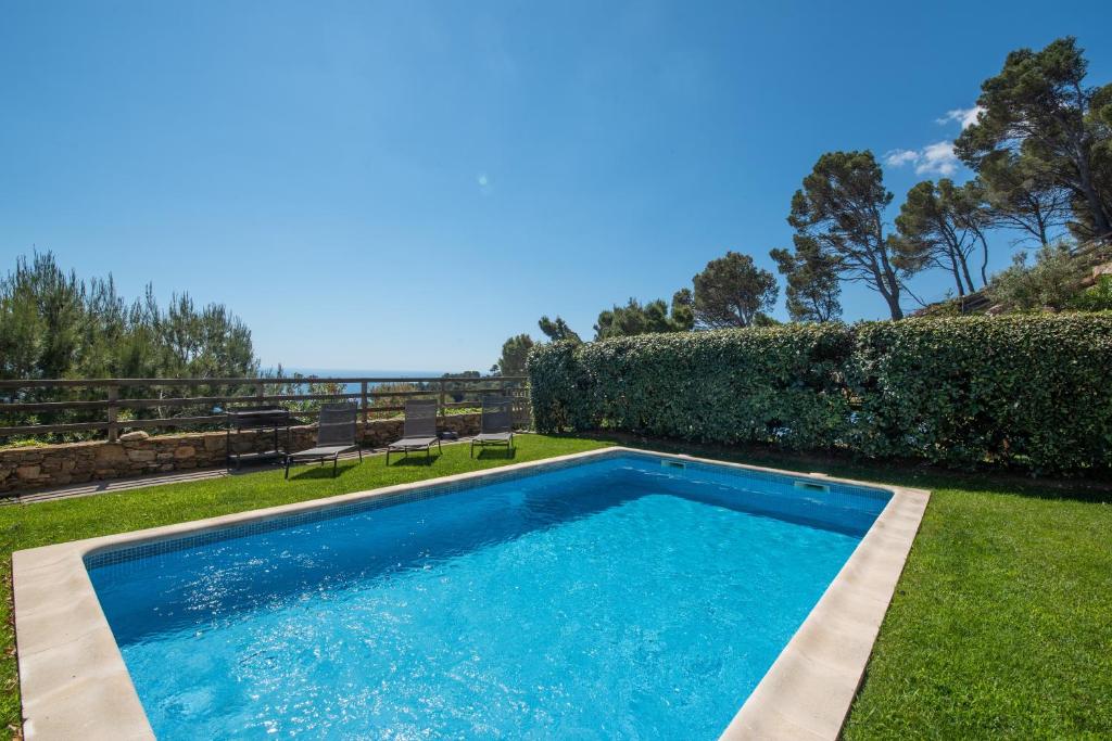 a swimming pool in the yard of a house at Casa Marbello - Begur in Begur