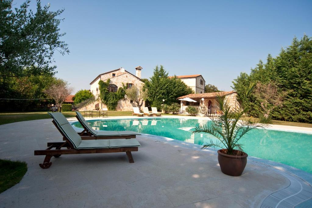 a chair sitting next to a swimming pool at Villa Lav in Bale