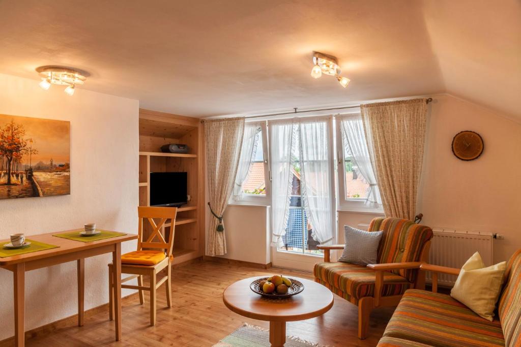 a living room with a couch and a table at Ferienwohnung Lengdobler - Burgi in Bad Kohlgrub