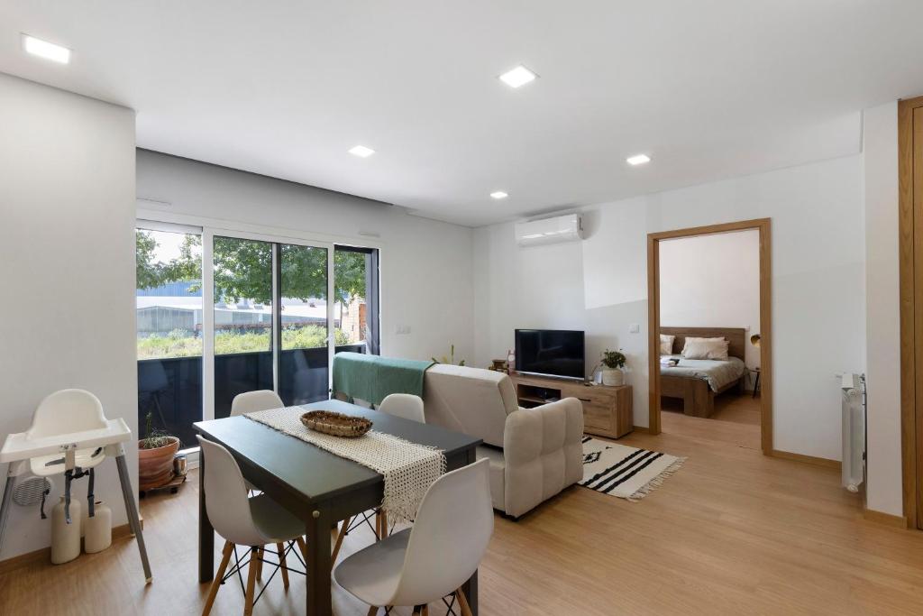 a living room with a table and chairs and a bedroom at Vale viver in Vale de Cambra