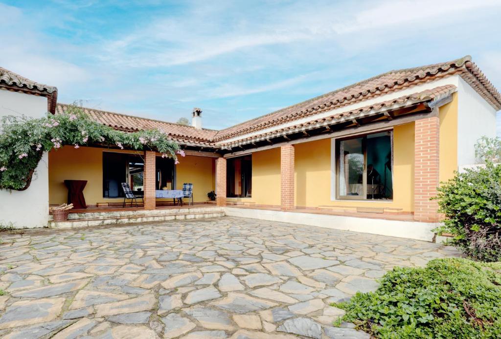 a house with a stone patio in front of it at Finca Los Pajaros in San Pablo