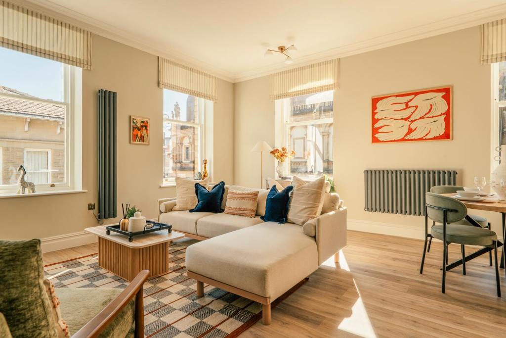 a living room with a couch and a table at St James Apartments - Harrogate in Harrogate
