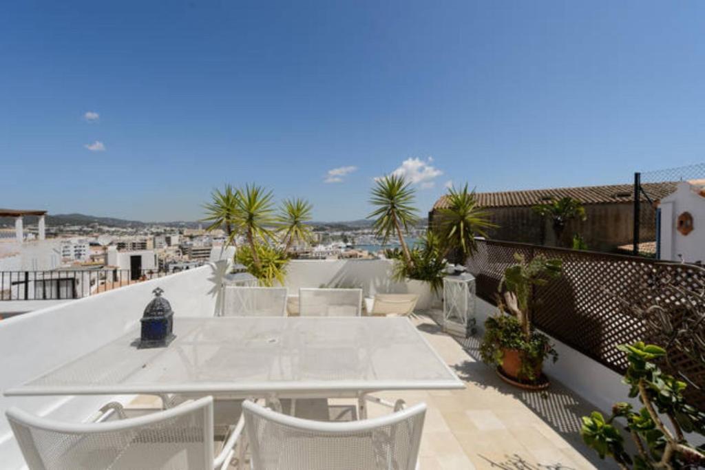 a white table and chairs on a balcony at Dalt Vila House in Ibiza Town