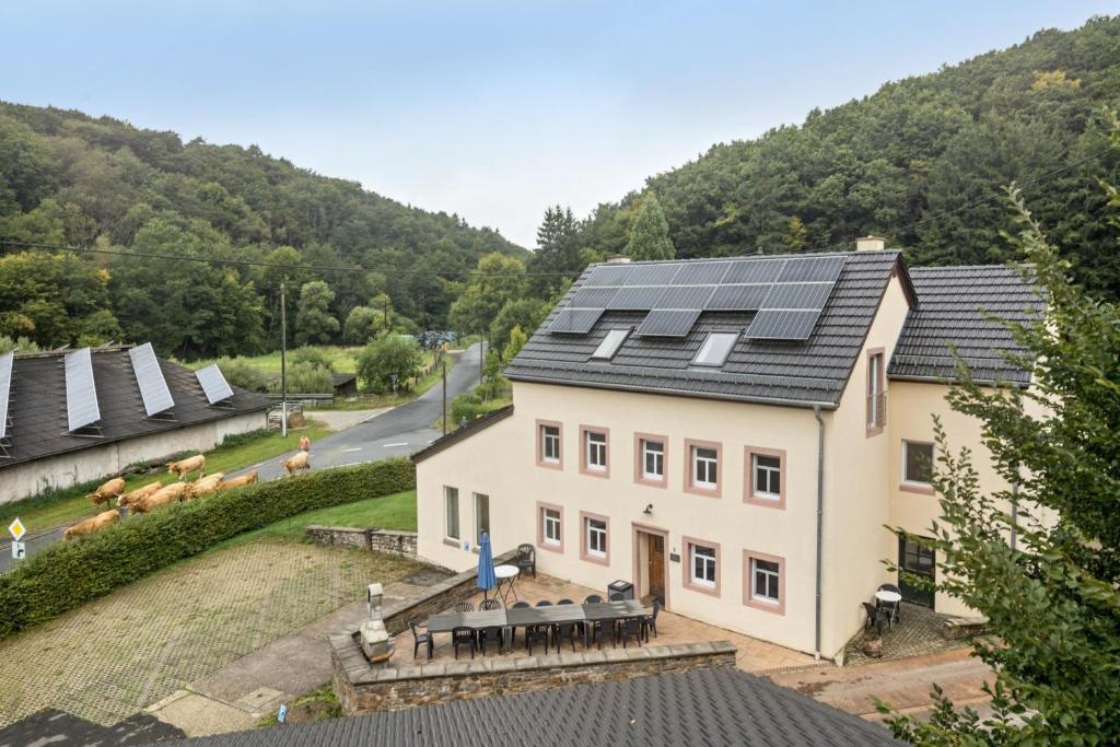 an image of a house with solar panels on the roof at Ferienhaus Eifellandhaus in Zweifelscheid