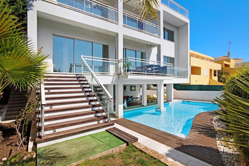 a villa with a swimming pool and a house at Villa Rosana in Albufeira