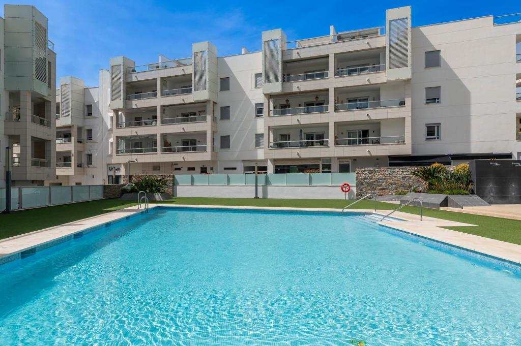 a swimming pool in front of a building at Acogedor apartamento 2 dormitorios in Marbella
