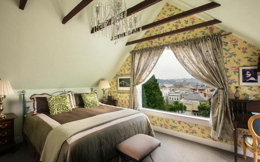 a bedroom with a bed and a large window at Noe's Nest Bed and Breakfast in San Francisco