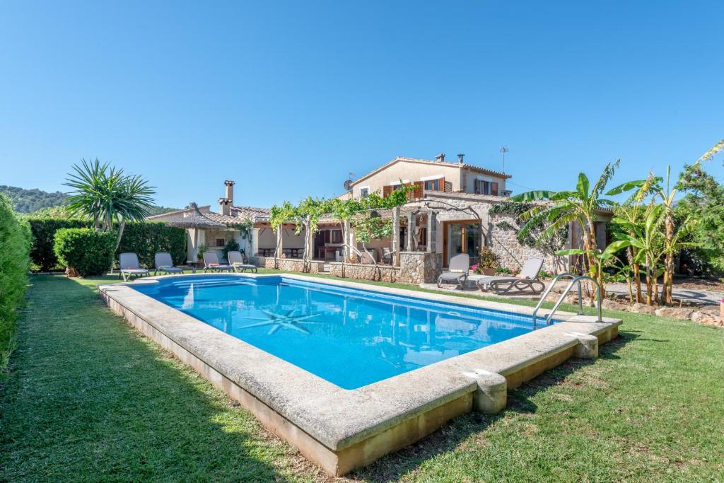 a swimming pool in the yard of a house at La Sorteta De Cuxach in Pollença