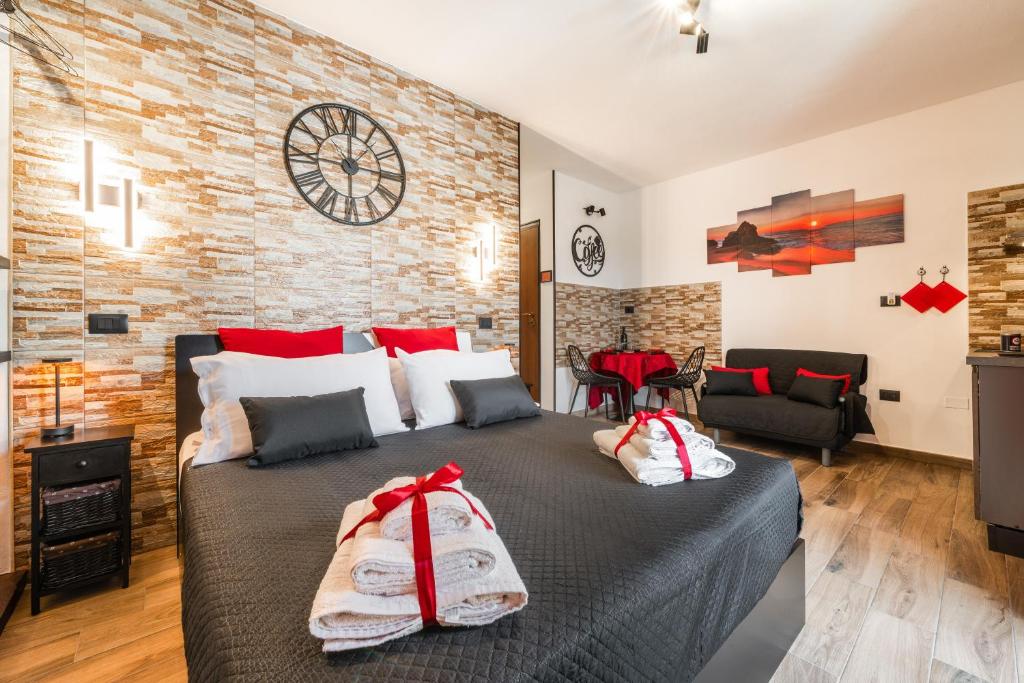 a bedroom with a large bed with red and white towels at Attilio's House in Capoterra