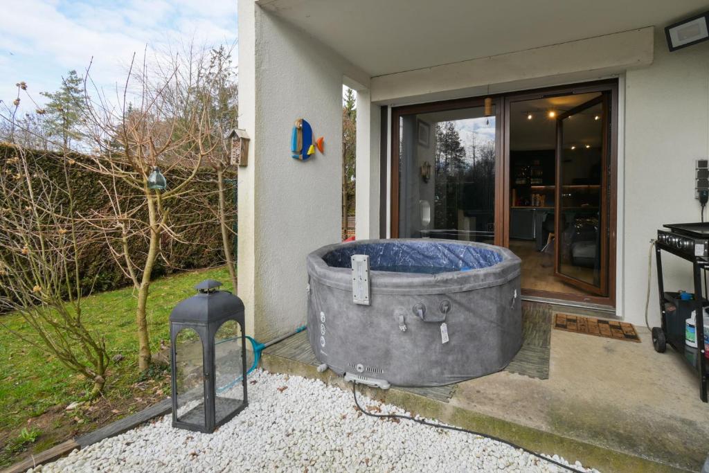 a large tub sitting outside of a house at Annecy Garden Spa Billiards in Annecy