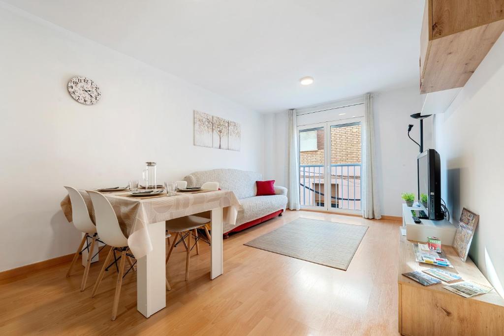 a white living room with a table and a couch at Canana De Vega in Flix