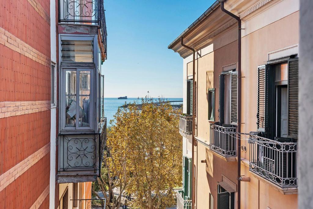 a view of the ocean from between two buildings at Civico 32 in Salerno
