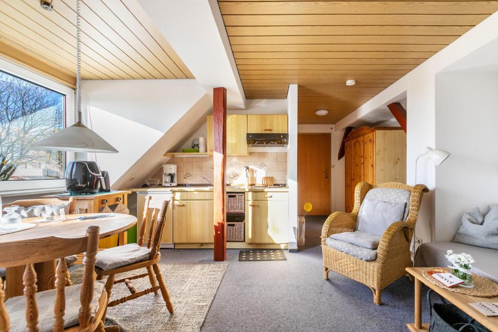 a kitchen and living room with a table and chairs at Whg 1- Ferien auf einem Resthof in Schönhagen