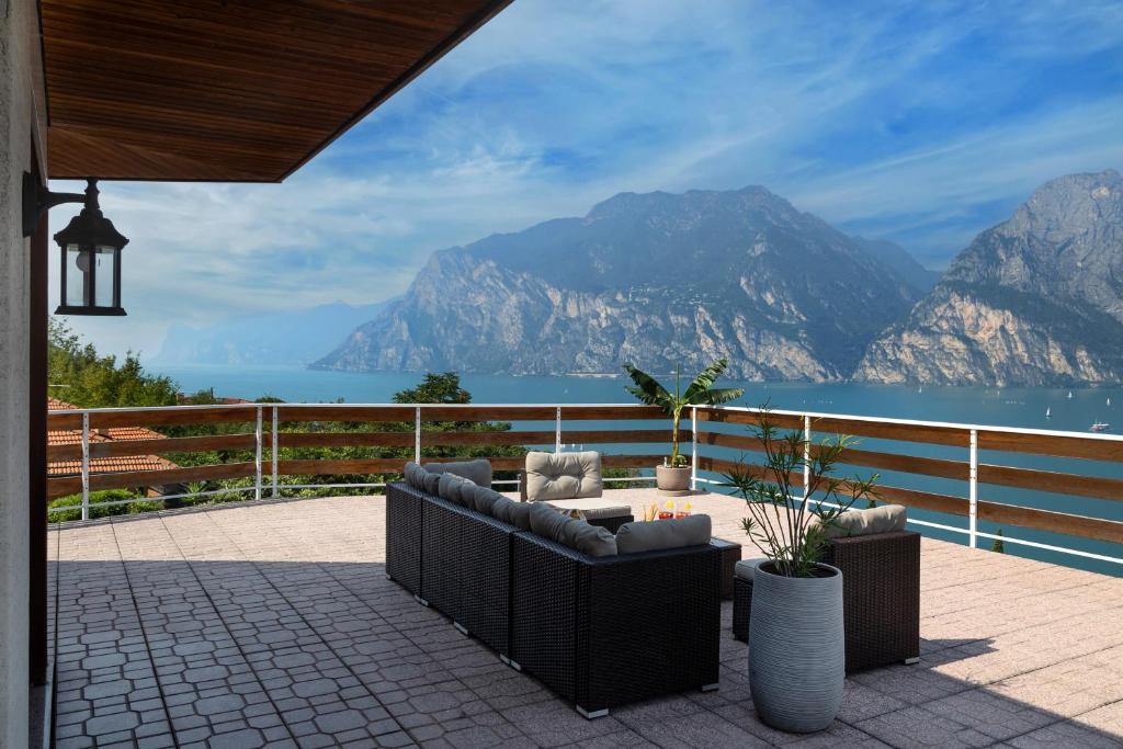 a patio with a view of the water and mountains at Panorama Apartment 180 mq in Nago-Torbole