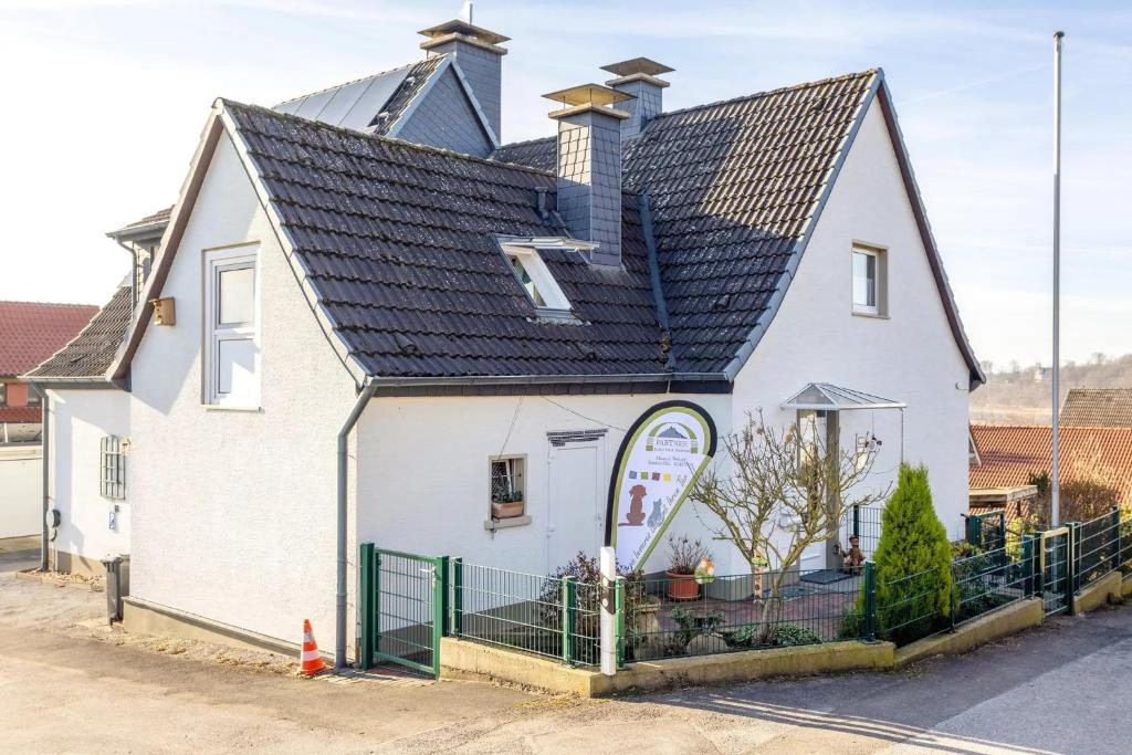 a white house with a black roof at Casa Felicitas Fewo und Studio in Möhnesee