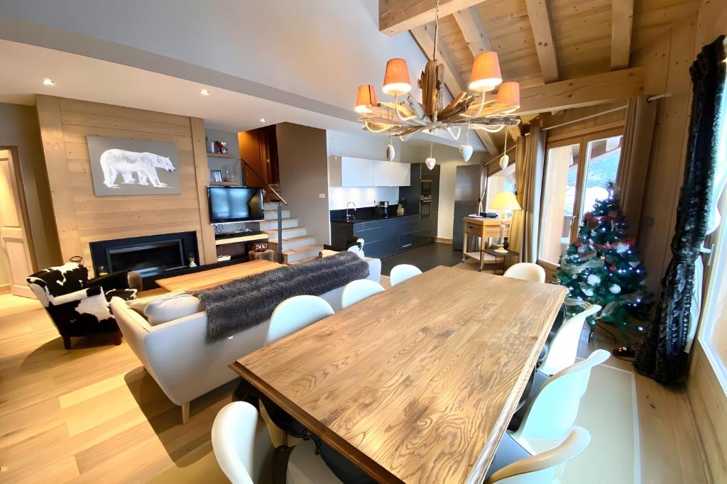 a living room with a table and a christmas tree at Les Craterelles 3 - 1650 in Courchevel