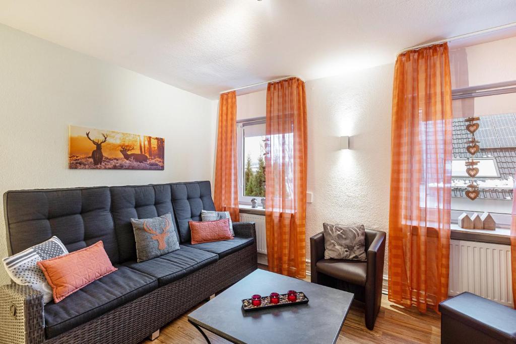 a living room with a couch and a table at Ferienwohnung Holterhoff in Olpe