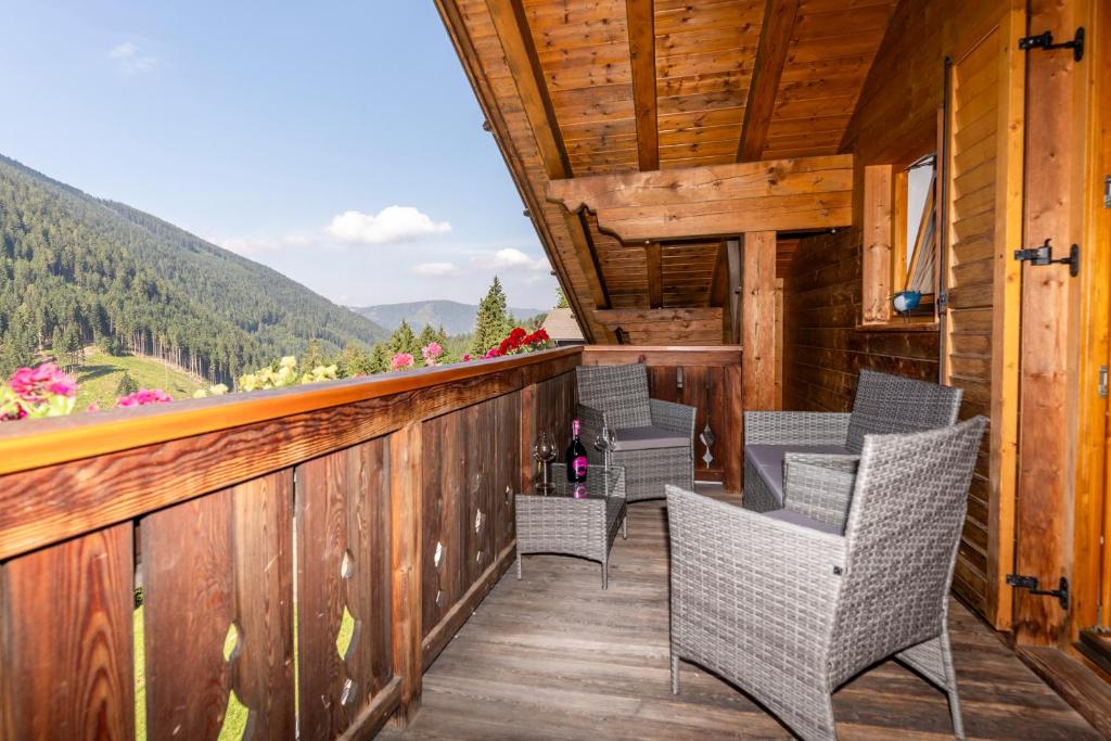 a balcony with chairs and a view of a mountain at Haus Simon in Nova Levante