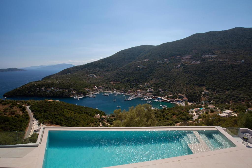 a swimming pool with a view of a lake at Villa Alexandra in Lefkada