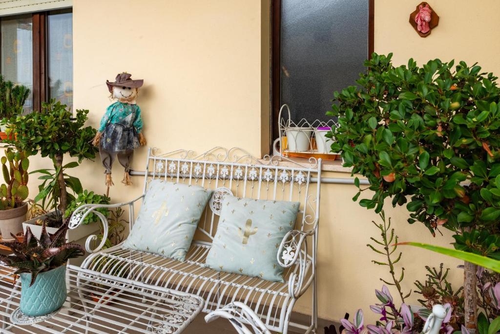 a white bench sitting on a porch with plants at Il Dolce Risveglio in Fossacesia