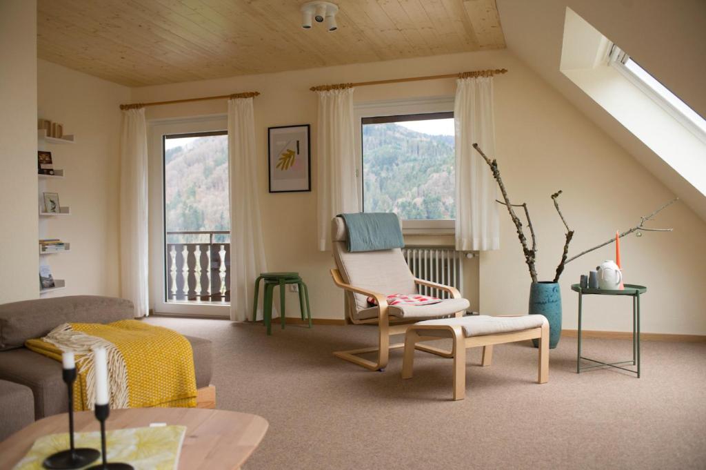 a living room with a couch and a chair at Gullerhof Ferienwohnung - Köpfle in Glottertal