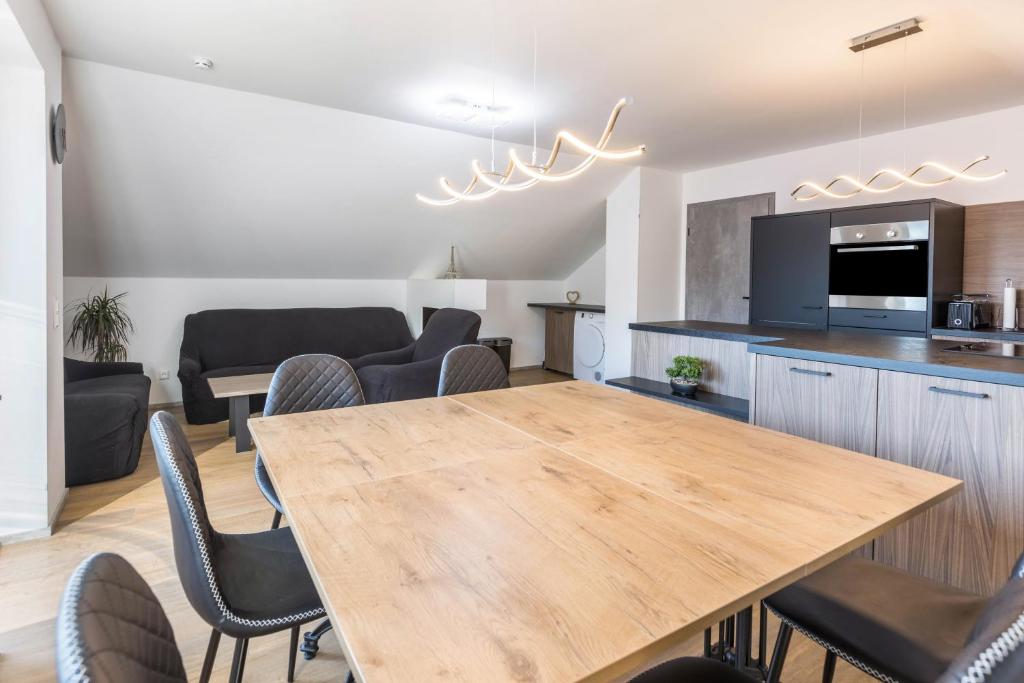 a kitchen and dining room with a wooden table and chairs at Zeichner in Geisingen